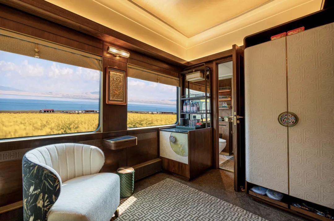 A Silk Road Express suite with the panoramic window open over farmland and a lake shore